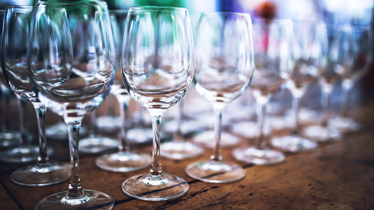 Rows of wine glasses on a table